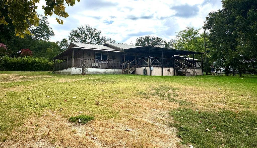 10122 Ash Cove, Wills Point, TX 75169 Expansive lot featuring mature trees, a covered porch, and a multi-level deck