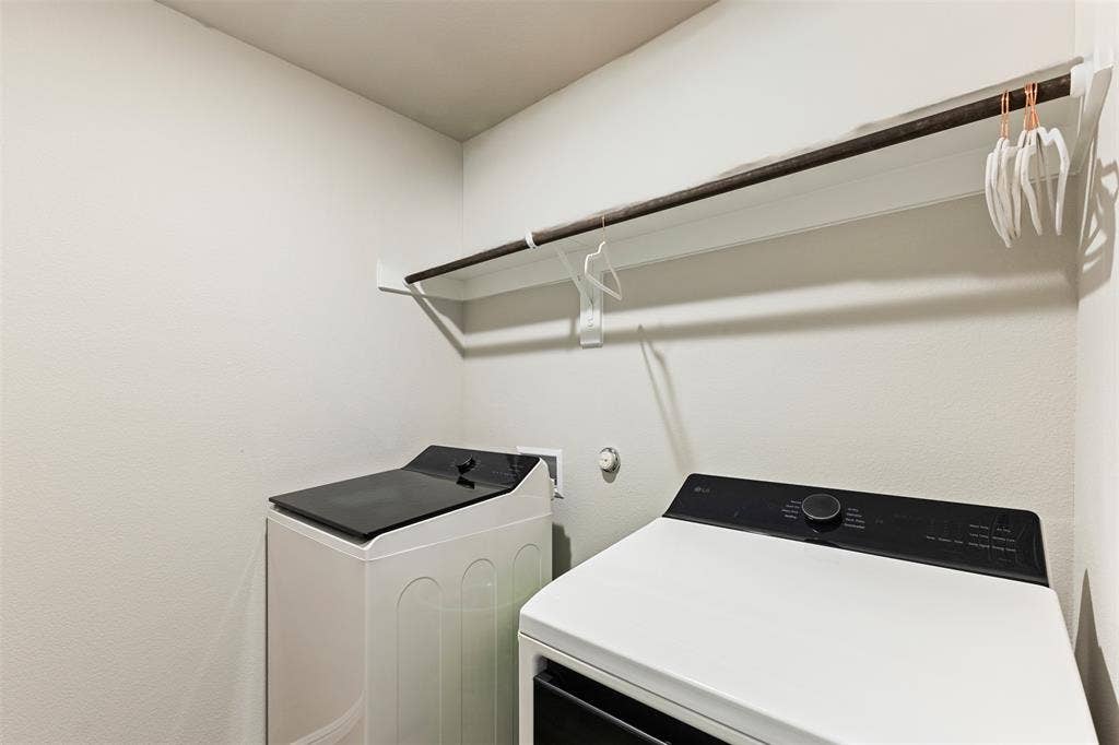 Washroom with washing machine and clothes dryer