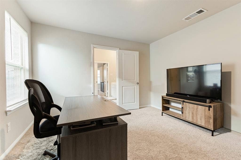 Home office featuring light colored carpet