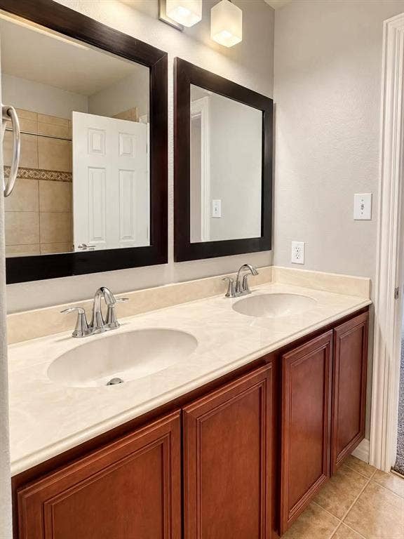 Double vanity featuring a light-toned countertop with integrated sinks and chrome faucets