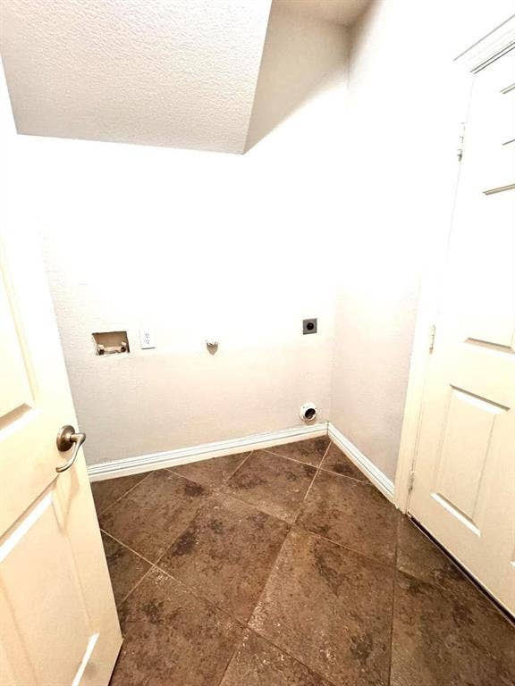 Tile flooring, white walls, and a textured ceiling
