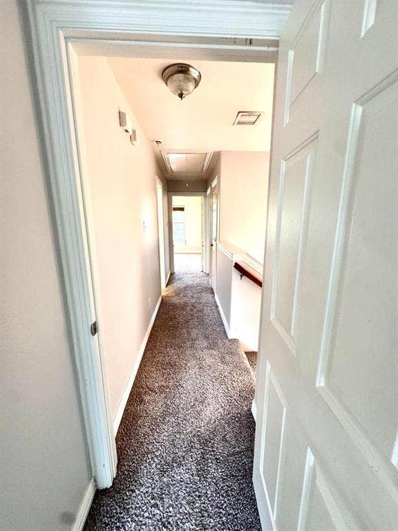 Hallway featuring carpet flooring, painted walls, and a flush mount light fixture