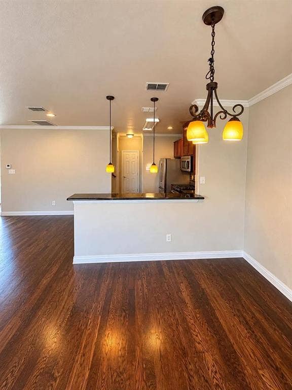 Wood-finish flooring throughout, complemented by crown molding and recessed lighting