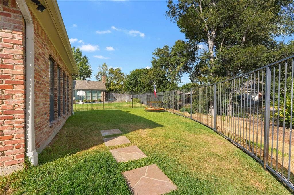 1312 Chippewa Drive, Plano, TX 75093 Rear lawn outside master bedroom along the home’s greenbelt-facing side.
