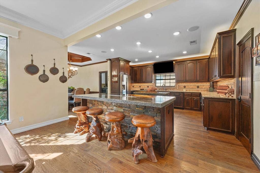1312 Chippewa Drive, Plano, TX 75093 Chef’s kitchen with two custom islands, chiseled-edge granite and extensive custom cabinetry.