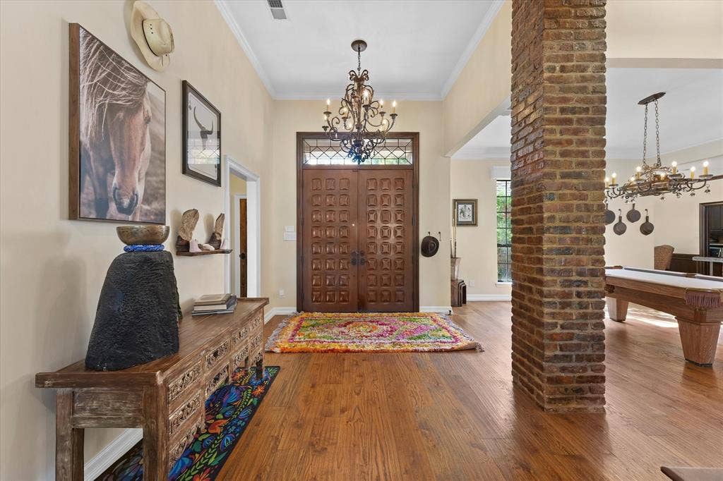 1312 Chippewa Drive, Plano, TX 75093 Custom mahogany double entry doors open to the connected main living spaces.