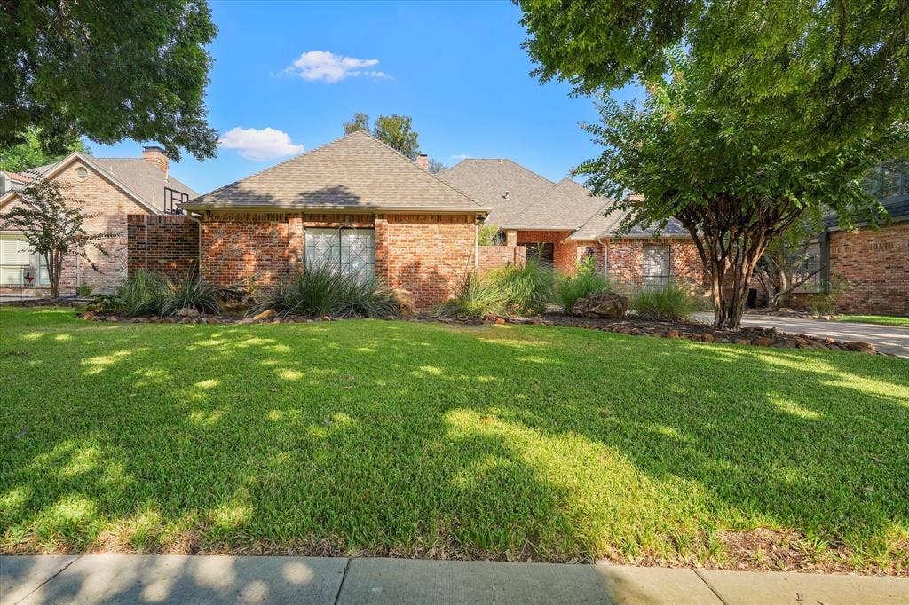 1312 Chippewa Drive, Plano, TX 75093 Daylight view of the brick exterior, mature trees and established landscaping.