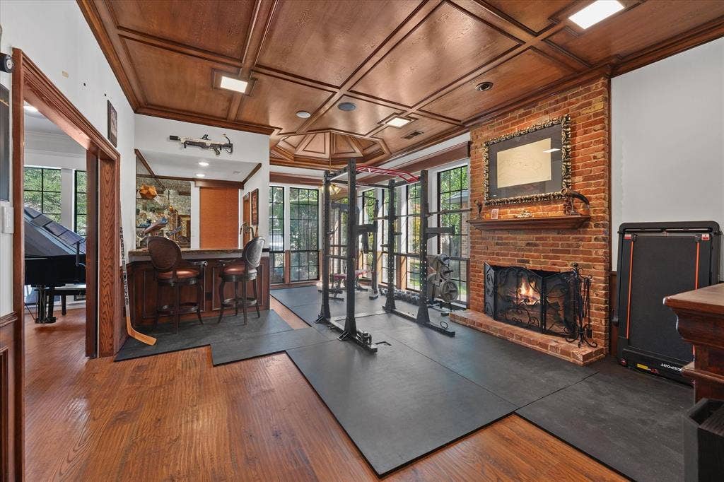 1312 Chippewa Drive, Plano, TX 75093 Vaulted den with a wood-paneled ceiling, wood-burning fireplace and custom wet bar.