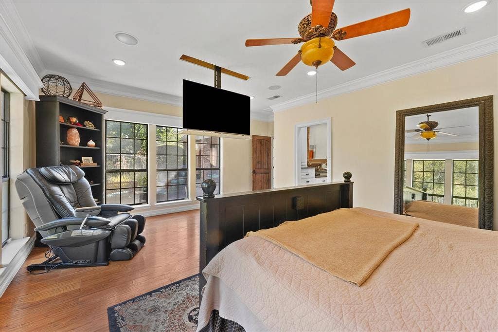 1312 Chippewa Drive, Plano, TX 75093 The primary suite includes a ceiling-mounted, drop-down television.