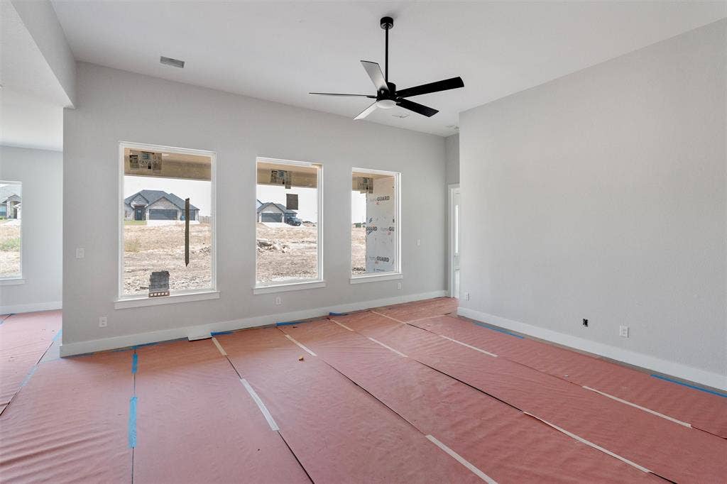1312 Tahonta Drive, Hewitt, TX 76643 Vaulted ceilings with a ceiling fan, multiple windows, and light gray wall paint