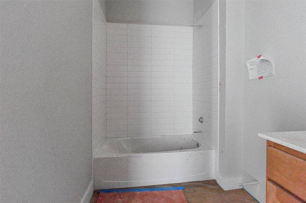 1312 Tahonta Drive, Hewitt, TX 76643 Bathtub with white subway tile surround and chrome fixtures