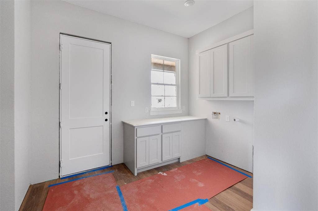 1312 Tahonta Drive, Hewitt, TX 76643 White shaker cabinetry, light-toned countertops, white interior door, and window