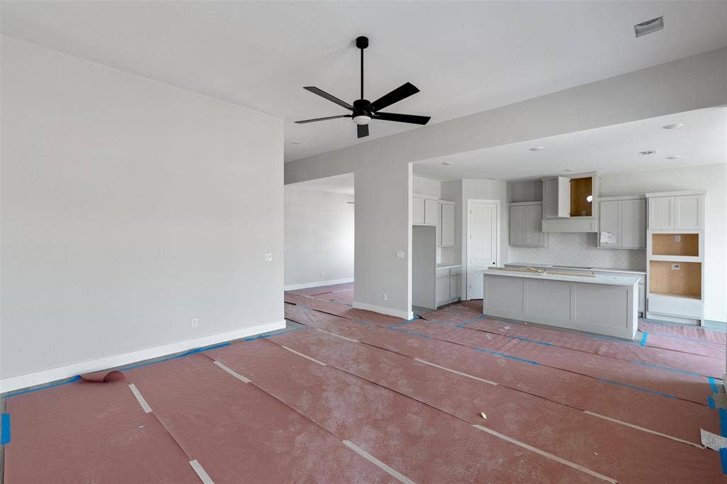 1312 Tahonta Drive, Hewitt, TX 76643 Open-concept living area with a contemporary kitchen featuring light gray cabinetry and a central island