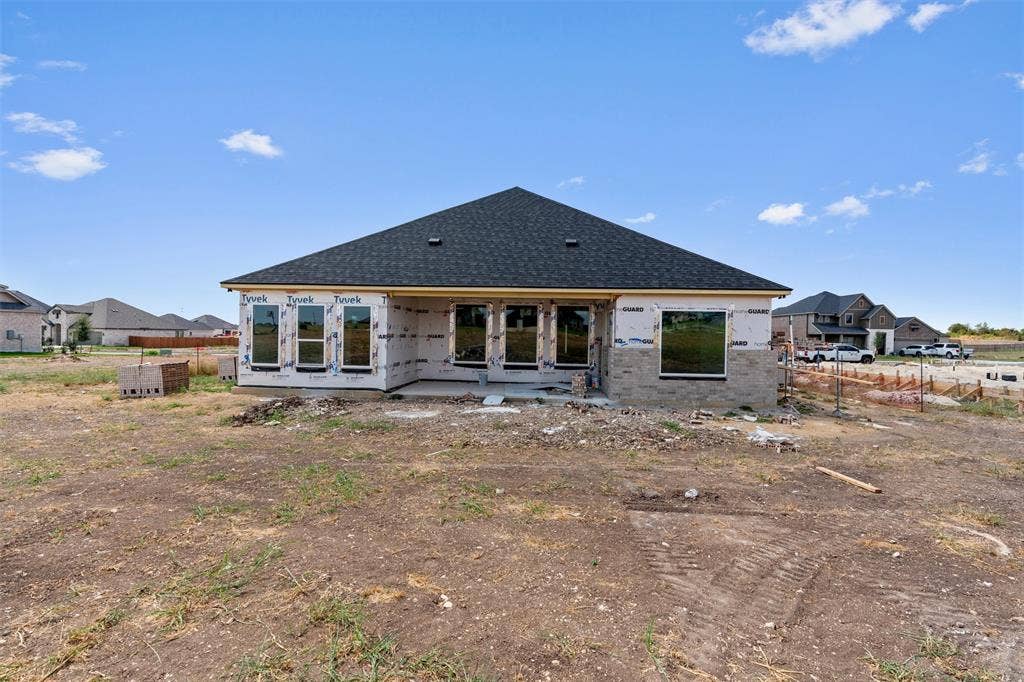 1312 Tahonta Drive, Hewitt, TX 76643 New construction residence featuring a dark shingle roof and multiple windows