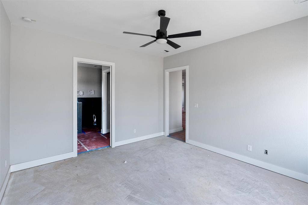1312 Tahonta Drive, Hewitt, TX 76643 Neutral gray wall paint, white trim, and a black ceiling fan