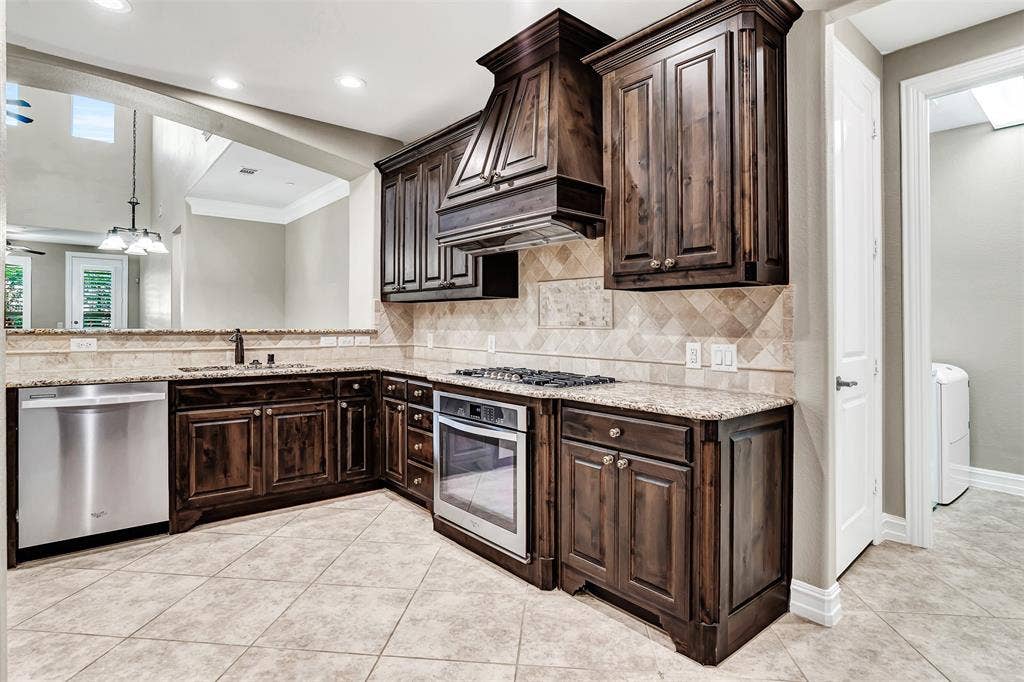 4817 BAYVIEW Drive, Plano, TX 75093 The kitchen has a large pantry, plus the utility room and access to the 2 car garage.