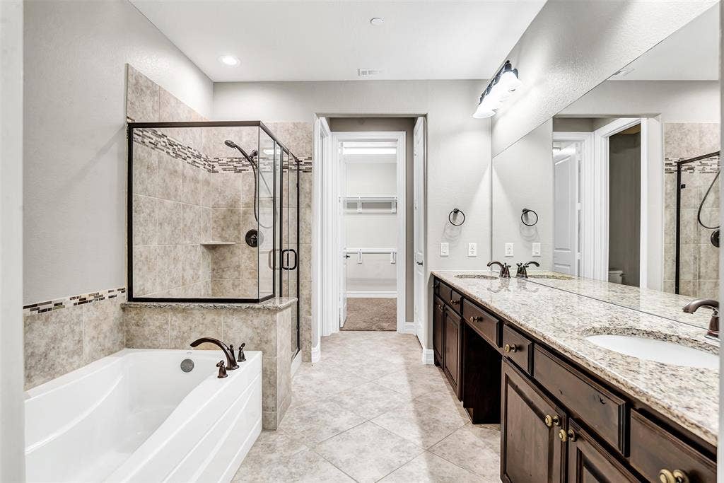 4817 BAYVIEW Drive, Plano, TX 75093 This townhome is full of surprises, including this large master bath! Dual sinks in a large vanity, separate tub and shower plus a HUGE walk-in closet and a linen closet!