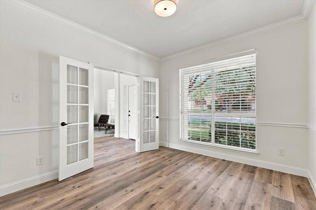 The light filled office boasts a French Door entry.