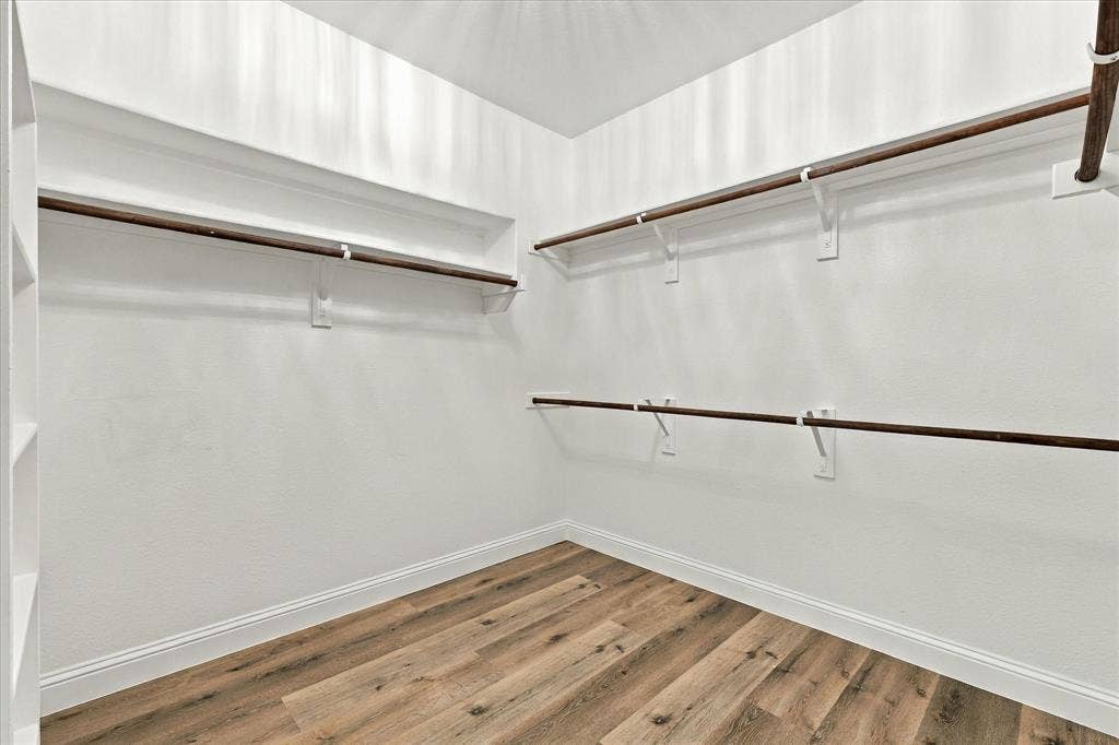 The primary closet offers luxury vinyl plank flooring.