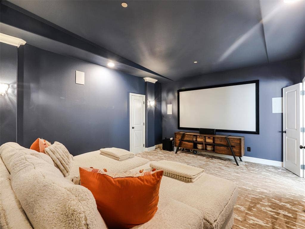 12313 Winding Hollow Lane, Frisco, TX 75033 A dedicated media room, complete with projector, receiver, and speakers, brings the movie theater experience home, while the downstairs living areas are fully wired for surround sound