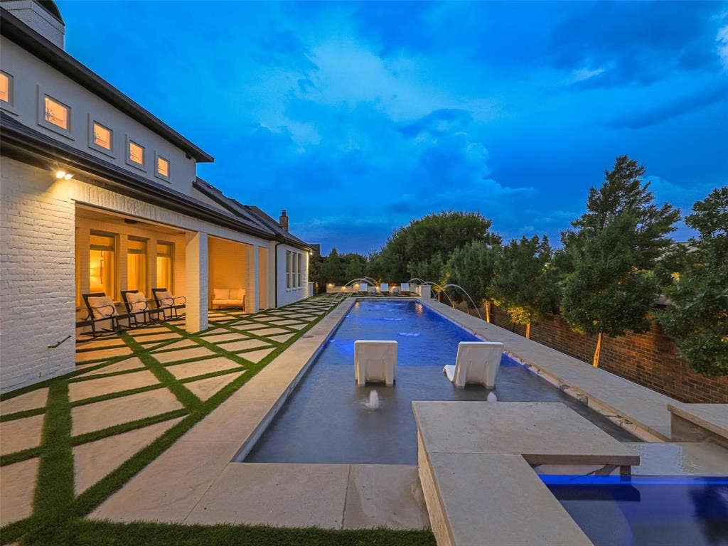 12313 Winding Hollow Lane, Frisco, TX 75033 While the interior is impressive, the outdoor living environment elevates this Newman Village home to another level. Designed as a private resort, the backyard centers around a custom heated pool completed in 2023. The pool is equipped with two Speck X commercial-grade swim jets, allowing for an enhanced swimming experience without leaving home. Eight deck jets add movement and visual interest, while the tanning ledge creates a relaxing space for enjoying warm Texas afternoons. Polaris equipment completes the thoughtfully designed pool system.The pool area also includes three chaise lounges, two side tables, two umbrella stands, and two Ledge Lounger chairs, creating multiple spaces for relaxing poolside. Whether enjoying a quiet afternoon in the sun or entertaining friends and family, the backyard was designed to accommodate both intimate gatherings and larger celebrations. Attached to the pool is an impressive custom spa completed in 2023. Designed to accommodate up to 18 people and featuring 18 jets.