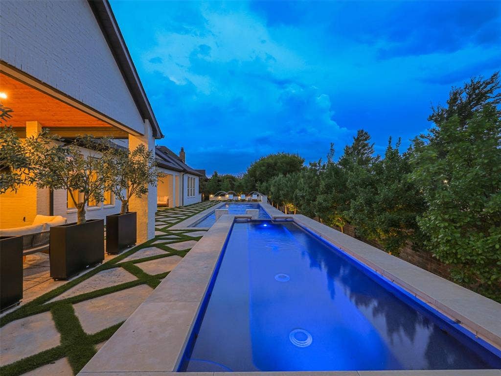 12313 Winding Hollow Lane, Frisco, TX 75033 While the interior is impressive, the outdoor living environment elevates this Newman Village home to another level. Designed as a private resort, the backyard centers around a custom heated pool completed in 2023. The pool is equipped with two Speck X commercial-grade swim jets, allowing for an enhanced swimming experience without leaving home. Eight deck jets add movement and visual interest, while the tanning ledge creates a relaxing space for enjoying warm Texas afternoons. Polaris equipment completes the thoughtfully designed pool system.The pool area also includes three chaise lounges, two side tables, two umbrella stands, and two Ledge Lounger chairs, creating multiple spaces for relaxing poolside. Whether enjoying a quiet afternoon in the sun or entertaining friends and family, the backyard was designed to accommodate both intimate gatherings and larger celebrations. Attached to the pool is an impressive custom spa completed in 2023. Designed to accommodate up to 18 people and featuring 18 jets.