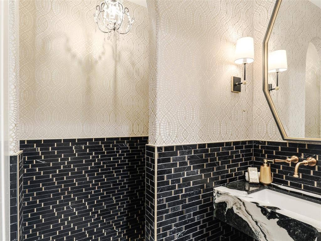 12313 Winding Hollow Lane, Frisco, TX 75033 Pool Bath: Moen Colinet Wall Mounted Widespread Brushed Gold bathroom faucet.Signature Hardware Myers 21" Vitreous China Undermount Sink. Uttermost Savion 24"w Contemporary Urban Octagon Wall Mirror. Wallpaper: York Wallpaper