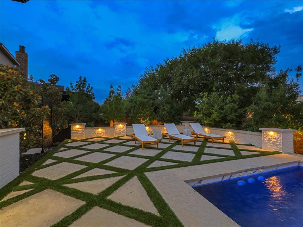 12313 Winding Hollow Lane, Frisco, TX 75033 While the interior is impressive, the outdoor living environment elevates this Newman Village home to another level. Designed as a private resort, the backyard centers around a custom heated pool completed in 2023. The pool is equipped with two Speck X commercial-grade swim jets, allowing for an enhanced swimming experience without leaving home. Eight deck jets add movement and visual interest, while the tanning ledge creates a relaxing space for enjoying warm Texas afternoons. Polaris equipment completes the thoughtfully designed pool system.The pool area also includes three chaise lounges, two side tables, two umbrella stands, and two Ledge Lounger chairs, creating multiple spaces for relaxing poolside. Whether enjoying a quiet afternoon in the sun or entertaining friends and family, the backyard was designed to accommodate both intimate gatherings and larger celebrations. Attached to the pool is an impressive custom spa completed in 2023. Designed to accommodate up to 18 people and featuring 18 jets.