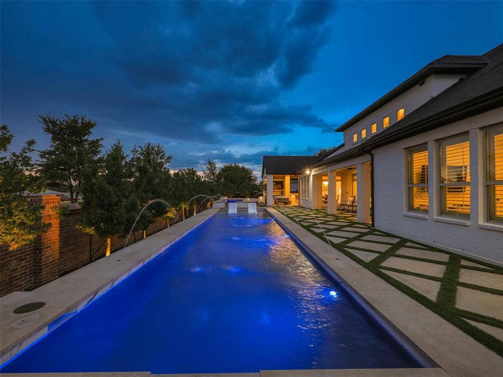 12313 Winding Hollow Lane, Frisco, TX 75033 While the interior is impressive, the outdoor living environment elevates this Newman Village home to another level. Designed as a private resort, the backyard centers around a custom heated pool completed in 2023. The pool is equipped with two Speck X commercial-grade swim jets, allowing for an enhanced swimming experience without leaving home. Eight deck jets add movement and visual interest, while the tanning ledge creates a relaxing space for enjoying warm Texas afternoons. Polaris equipment completes the thoughtfully designed pool system.The pool area also includes three chaise lounges, two side tables, two umbrella stands, and two Ledge Lounger chairs, creating multiple spaces for relaxing poolside. Whether enjoying a quiet afternoon in the sun or entertaining friends and family, the backyard was designed to accommodate both intimate gatherings and larger celebrations. Attached to the pool is an impressive custom spa completed in 2023. Designed to accommodate up to 18 people and featuring 18 jets.