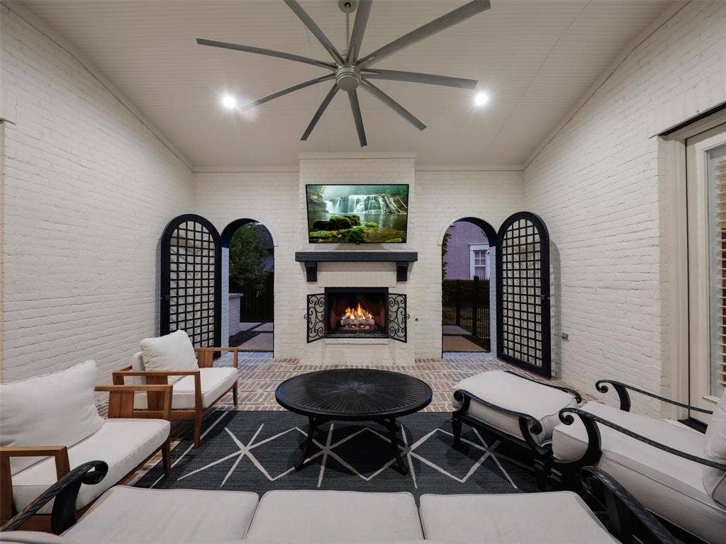 12313 Winding Hollow Lane, Frisco, TX 75033 A covered/uncovered 27x14x18 courtyard with a fireplace is right off of the private casita. Black iron doors (2023) SIDE YARD GRASS.