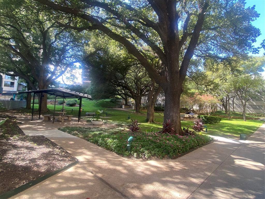 3883 Turtle Creek Boulevard, #411, Dallas, TX 75219 Beautiful private courtyard with pool, dog park, grills, trees and flowers.