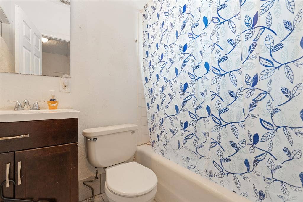 Vanity with white countertop, chrome faucet, and integrated sink
