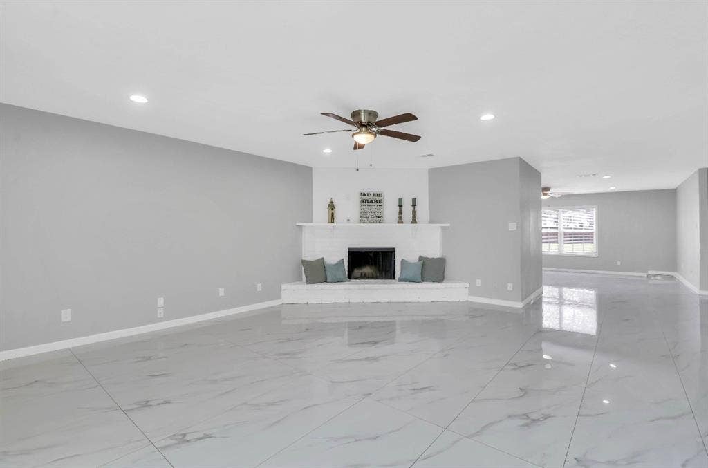1509 California Trail, Grand Prairie, TX 75052 Spacious living area featuring a white brick fireplace with mantel, ceiling fan, recessed lighting, and large format tile flooring