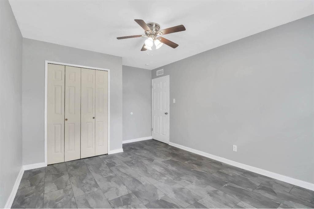 1509 California Trail, Grand Prairie, TX 75052 Spacious room featuring wood-finish flooring, a ceiling fan with integrated lighting, a bi-fold closet, and a white interior door