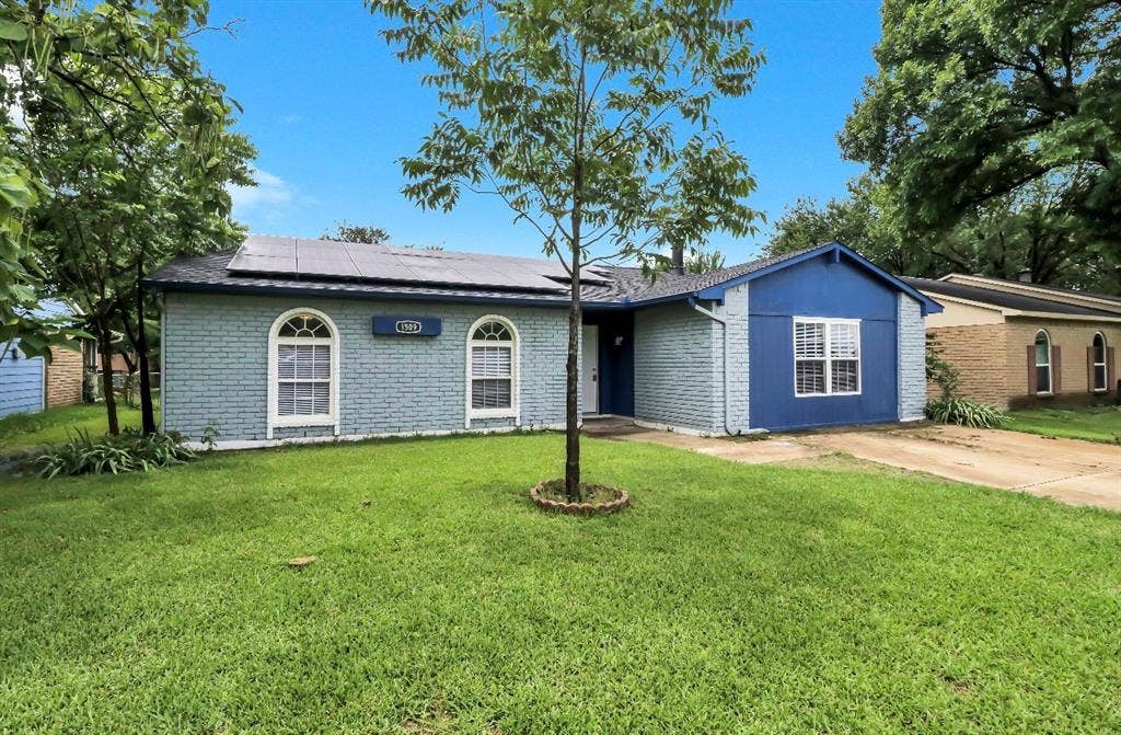 1509 California Trail, Grand Prairie, TX 75052 Single-story residence featuring a two-tone blue brick and siding exterior