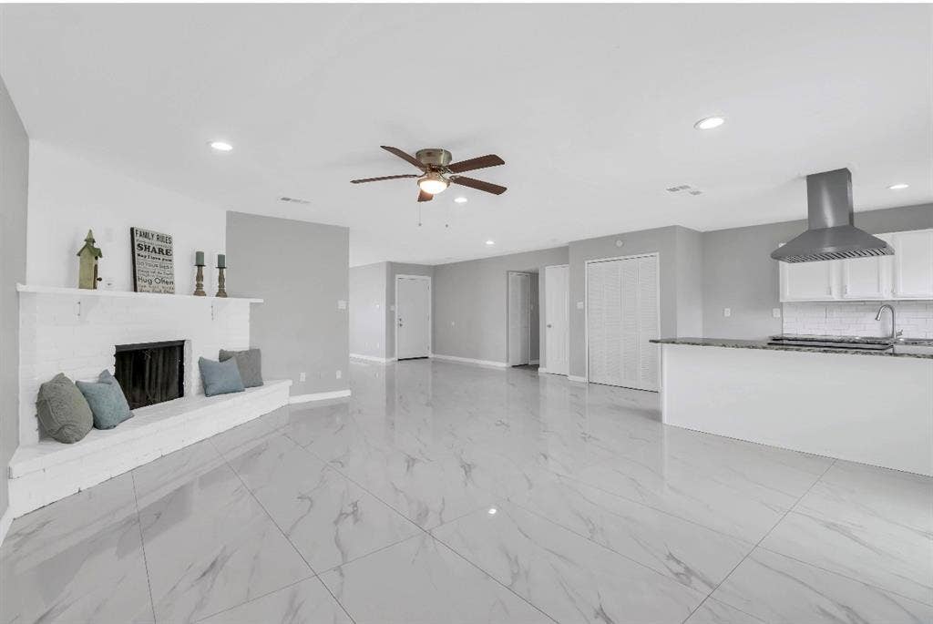 1509 California Trail, Grand Prairie, TX 75052 Spacious interior with large format tile flooring and a white brick fireplace