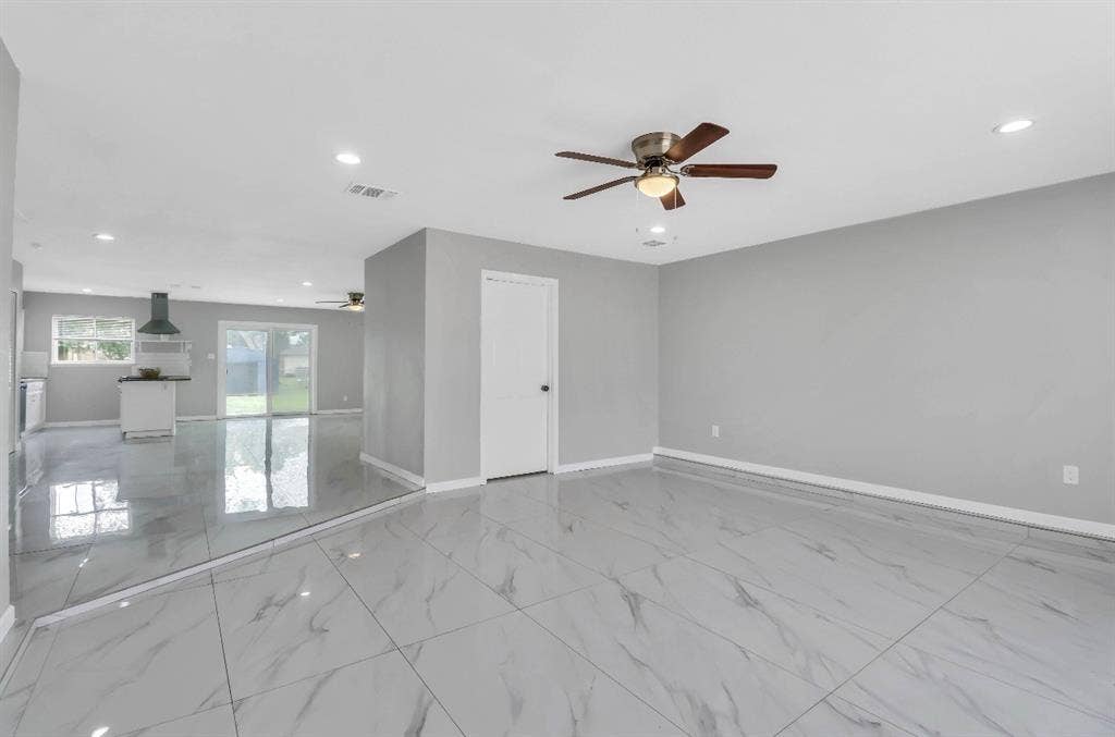 1509 California Trail, Grand Prairie, TX 75052 Spacious second family room featuring large format marble-look tile flooring, recessed lighting, and a ceiling fan