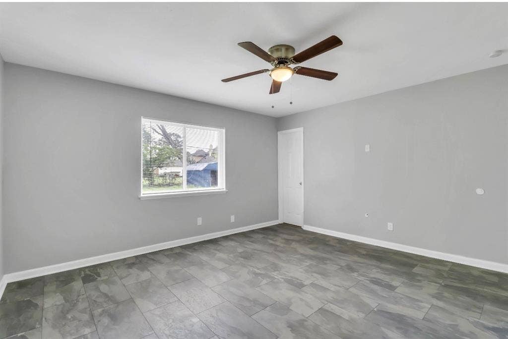 1509 California Trail, Grand Prairie, TX 75052 Spacious room featuring gray walls, wood-finish flooring, and white baseboards