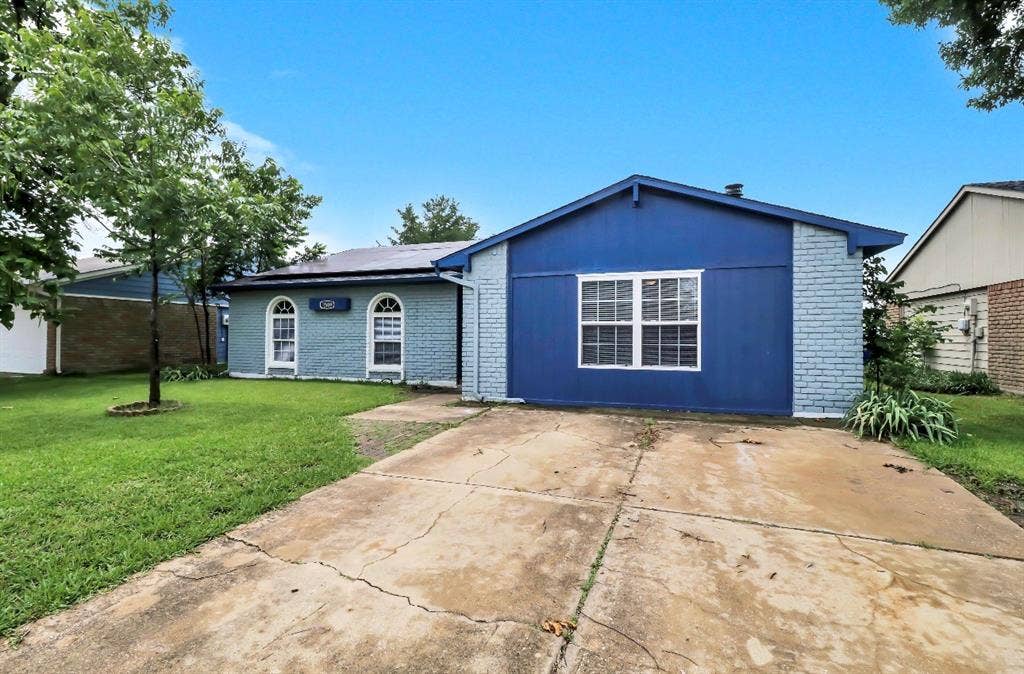 1509 California Trail, Grand Prairie, TX 75052 Blue exterior with white trim, featuring a concrete driveway and a manicured green lawn