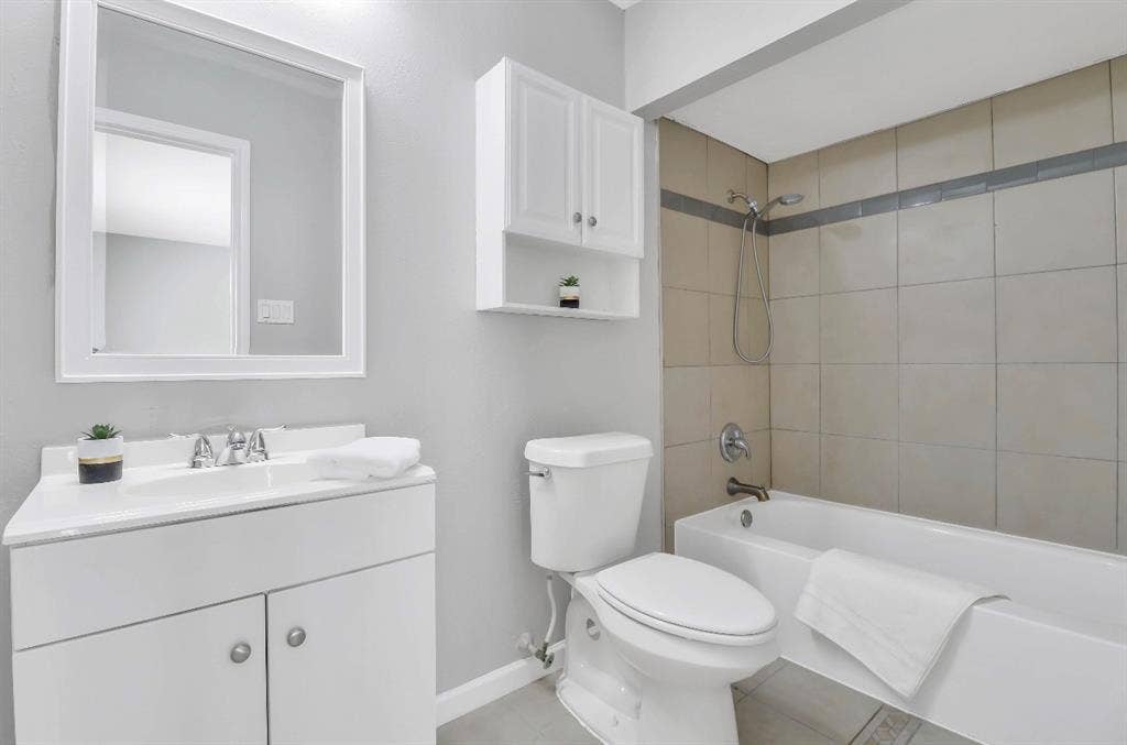 1509 California Trail, Grand Prairie, TX 75052 Bathroom featuring a white vanity with an integrated sink, framed mirror, and chrome fixtures