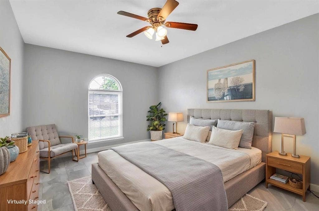 1509 California Trail, Grand Prairie, TX 75052 Vaulted ceiling with a ceiling fan, arched window, grey wall paint, grey flooring, and a built-in bed frame