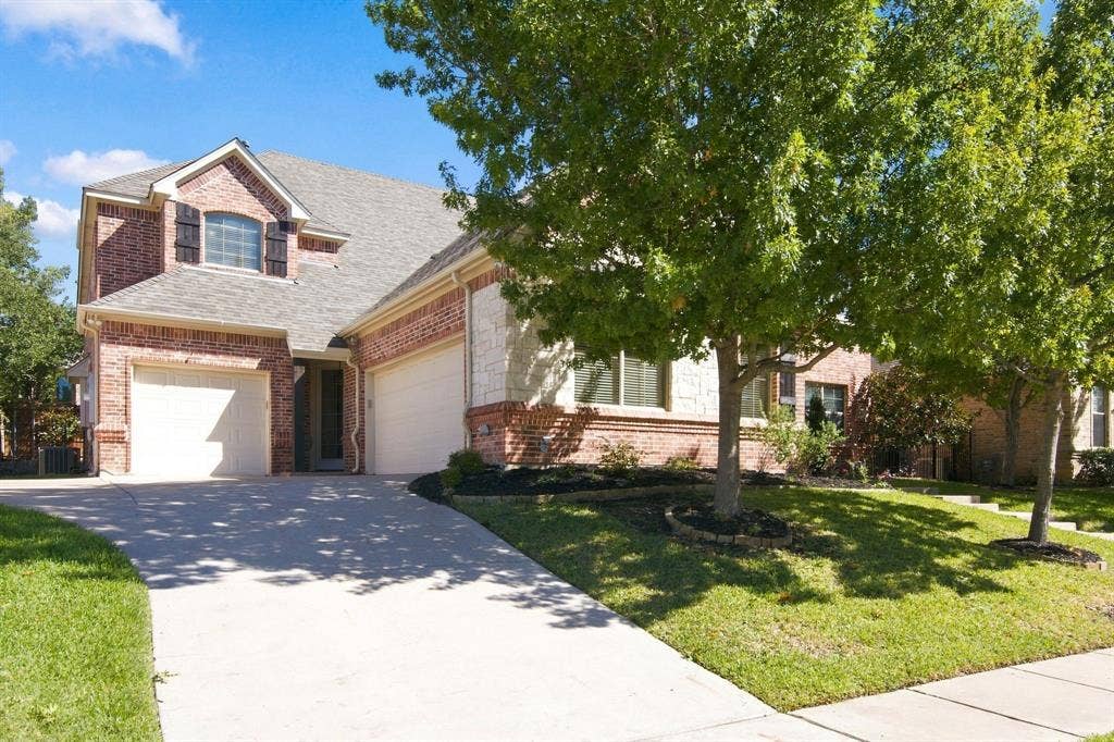 7004 Cherrybark Lane, North Richland Hills, TX 76182 Brick and stone exterior with a gabled roof
