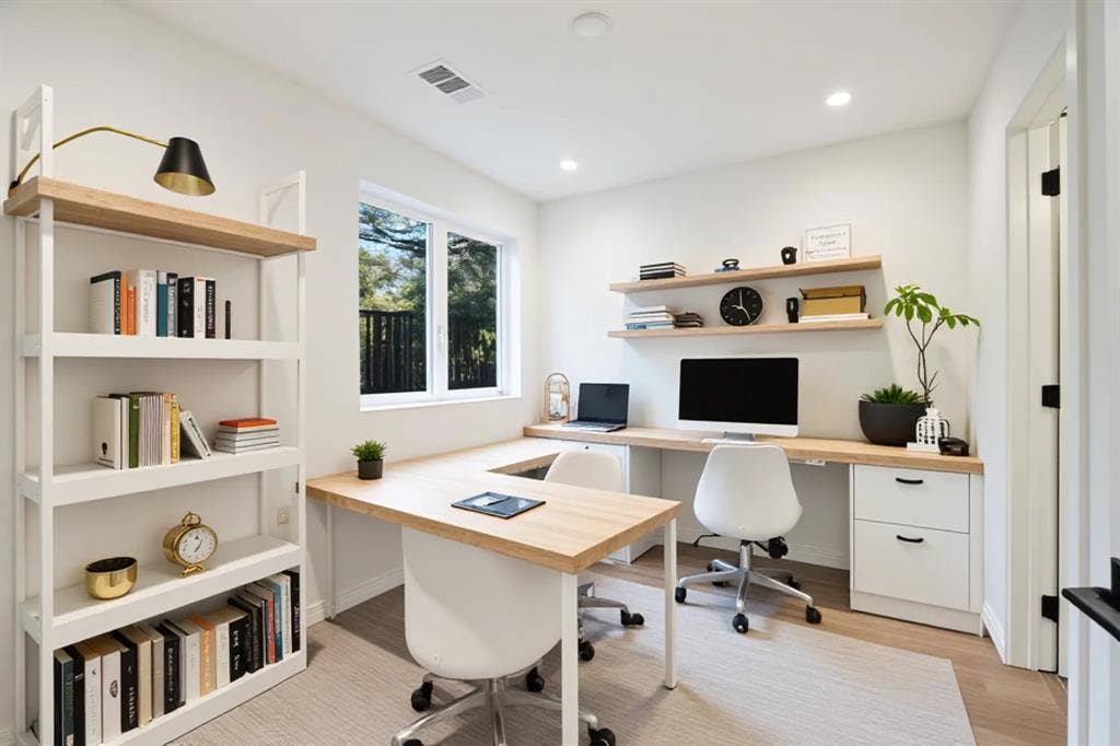 4811 Denton Drive, #201, Dallas, TX 75219 Integrated wood-finish desk with white cabinetry, built-in shelving, recessed lighting, and a large window