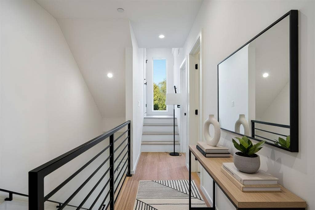4811 Denton Drive, #201, Dallas, TX 75219 Black railing, light wood flooring, leading up to the Patio