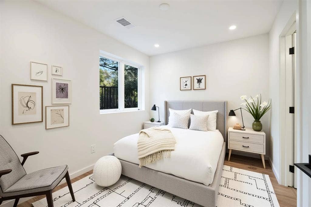 4811 Denton Drive, #201, Dallas, TX 75219 Recessed lighting illuminates the space, featuring a large window, wood-finish flooring, and crisp white walls