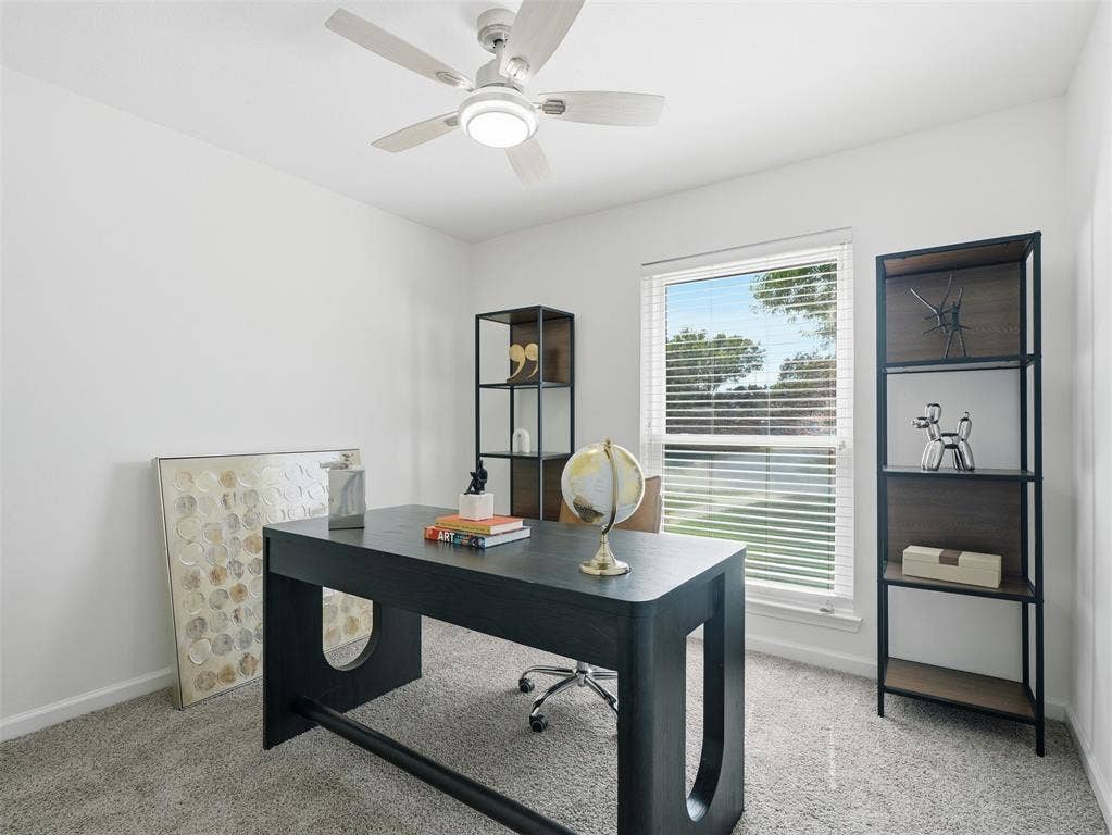 Recessed window with blinds, ceiling fan with integrated lighting, and neutral carpeting