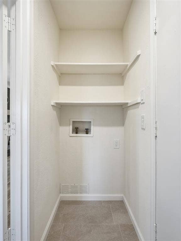 Utility closet with light beige wall paint