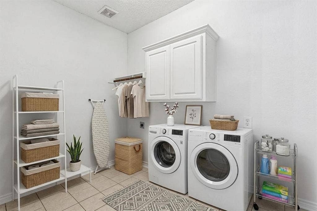 8121 Skyridge Drive, Plano, TX 75025 Dedicated utility room offers built-in cabinetry, a utility sink and space for full-size laundry appliances. *Virtually Staged*