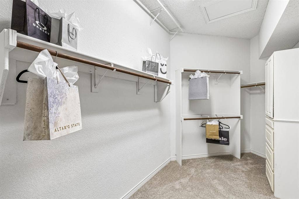 8121 Skyridge Drive, Plano, TX 75025 Phenomenal primary walk-in closet features a built-in dresser, tall ceilings and abundant room for seasonal storage.
