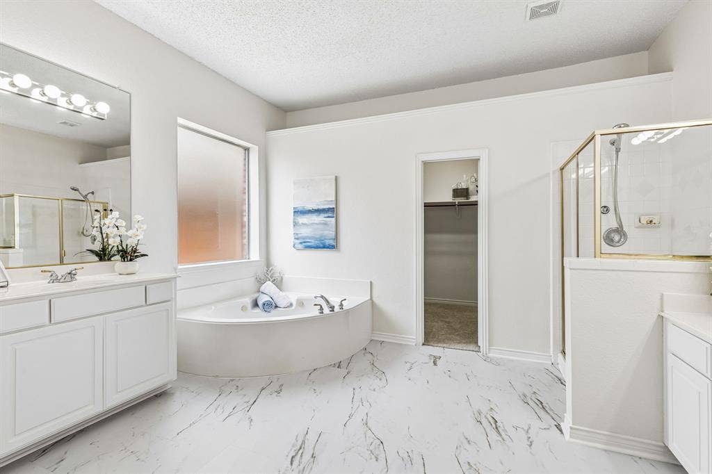 8121 Skyridge Drive, Plano, TX 75025 Generously sized primary bath features dual vanities, abundant cabinetry and recently refreshed painted cabinets.
